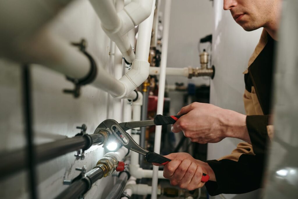 Plumbers maintaining commercial plumbing pipes in Lutz