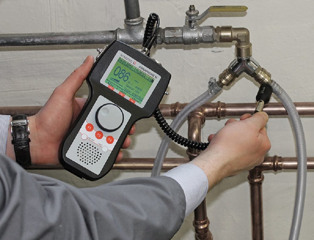 Plumber testing pipes with electronic leak detection equipment in Lutz