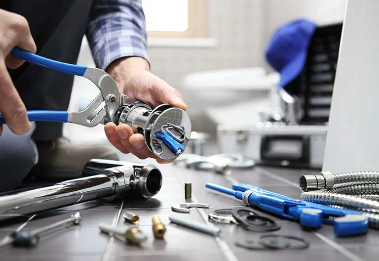 Technician repairing a plumbing fixture with professional tools in Lutz