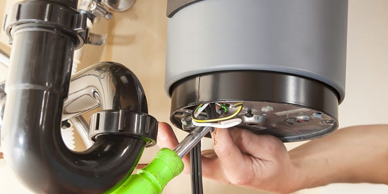 Technician repairing the heating element of a water heater in Lutz