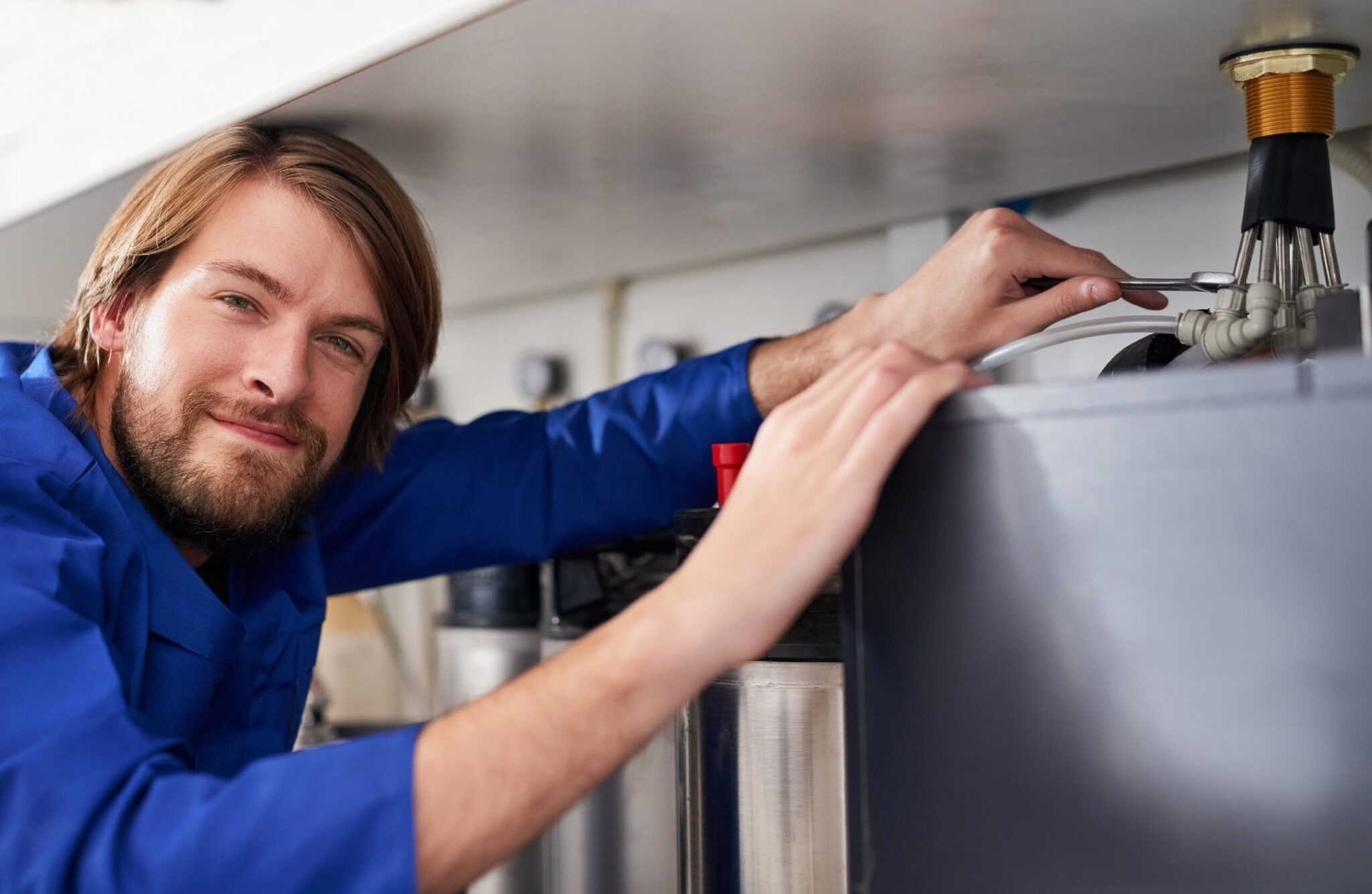 Technician servicing a residential water heater tank in Lutz